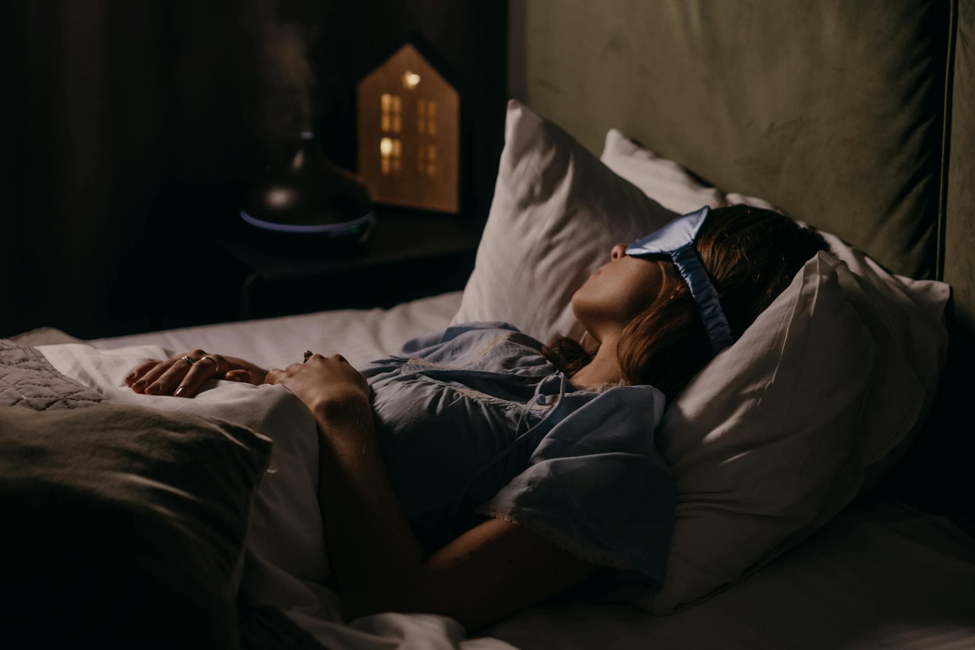Women sleeping with a night mask on before here eyes