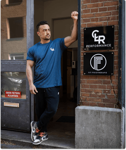 Muscle man standing inside the door post of his own gym