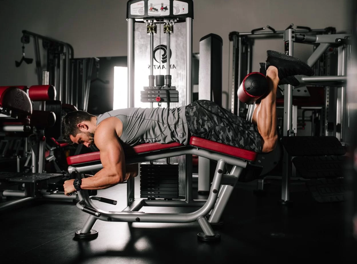 Image of a man training hes hamstrings on a lying leg curl