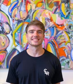 Picture of young male personal Trainer smiling wearing company shirt whats says CLR