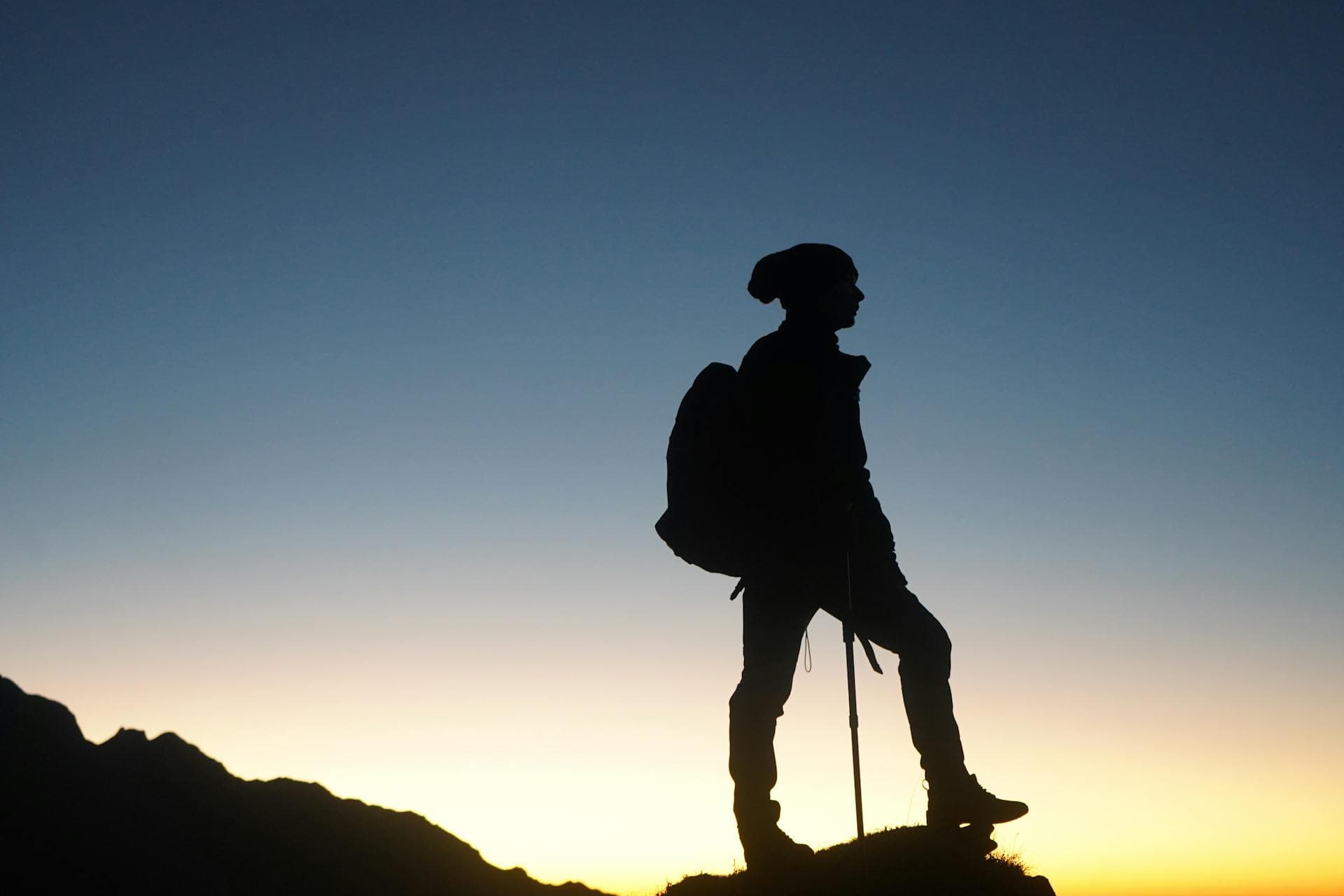 Man staring in the horizon on a top of mountain he is free